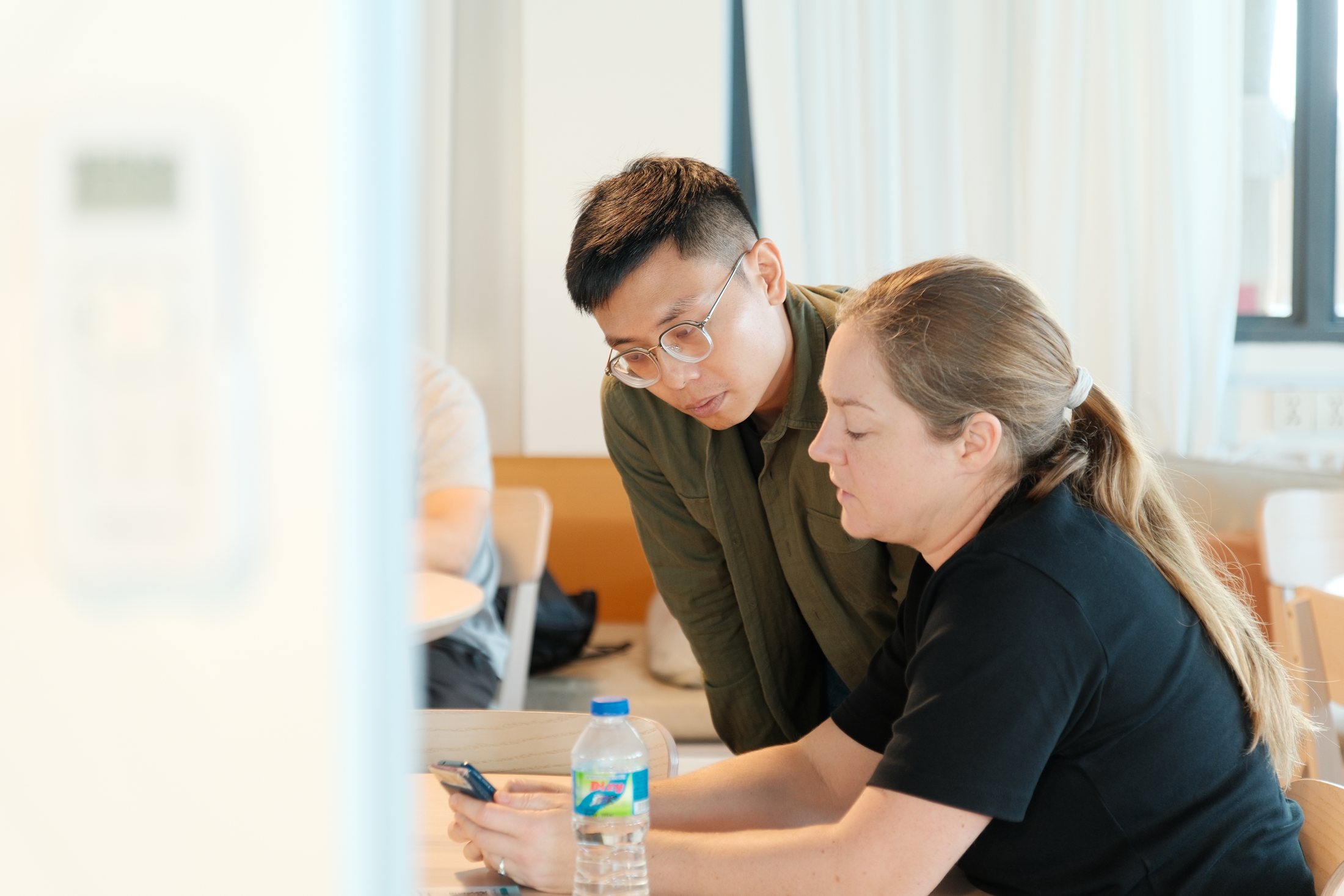 Tony listening to a participant and helping her work through The Modern Shrine on her phone