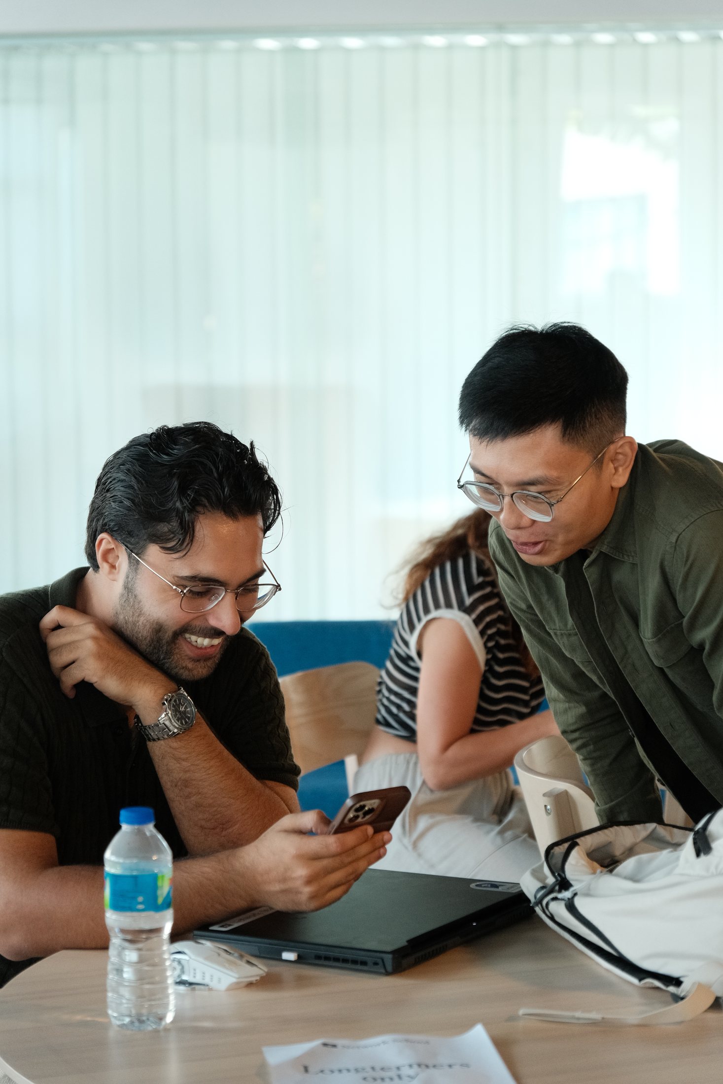 Tony helping a participant use The Modern Shrine on his phone during a workshop
